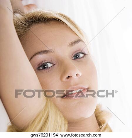 Portrait of a young woman lying on the bed View Large Photo Image Picture - Portrait of a young woman lying on the bed. Fotosearch