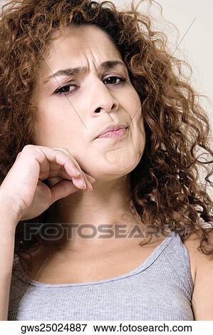 Stock Photo - Portrait of a young woman making a face. Fotosearch