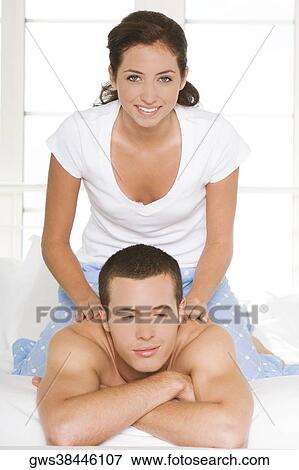 Portrait of a young woman massaging a young man's shoulders View Large Photo Image Stock Photo - Portrait of a young woman massaging a young man's shoulders. Fotosearch