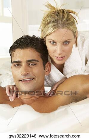 Portrait of a young woman massaging a young man in a bubble bath View Large Photo Image Stock Photo - Portrait of a young woman massaging a young man in a bubble bath. Fotosearch