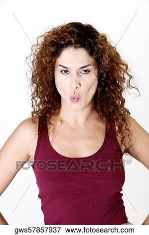 Stock Photo - Portrait of a young woman puckering her lips. Fotosearch