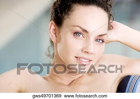 Portrait of a young woman relaxing at the poolside View Large Photo Image Stock Photo - Portrait of a young woman relaxing at the poolside. Fotosearch