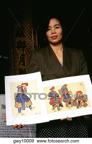 Portrait of a young woman showing paintings View Large Photo Image Stock Photo - Portrait of a young woman showing paintings. Fotosearch