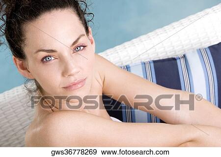 Portrait of a young woman sitting at the poolside View Large Photo Image Stock Photo - Portrait of a young woman sitting at the poolside. Fotosearch