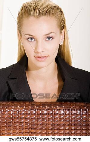 Portrait of a young woman sitting on a chair View Large Photo Image Stock Photography - Portrait of a young woman sitting on a chair. Fotosearch