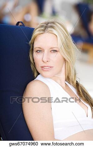 Portrait of a young woman sitting View Large Photo Image Stock Image - Portrait of a young woman sitting. Fotosearch