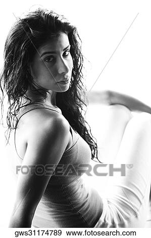 Stock Photo - Portrait of a young woman sitting. Fotosearch