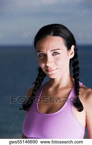 Stock Image - Portrait of a young woman smiling. Fotosearch