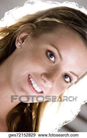 Stock Photo - Portrait of a young woman smiling. Fotosearch