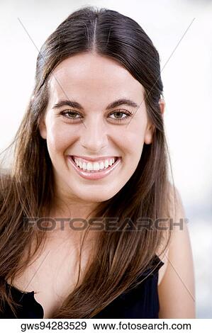 Portrait of a young woman smiling View Large Photo Image Stock Photo - Portrait of a young woman smiling. Fotosearch