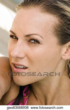 Stock Photograph - Portrait of a young woman smiling. Fotosearch