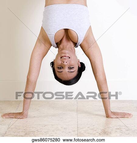 Portrait of a young woman standing on her hands View Large Photo Image Stock Image - Portrait of a young woman standing on her hands. Fotosearch