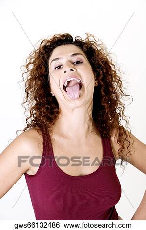 Portrait of a young woman sticking out her tongue View Large Photo Image Stock Photograph - Portrait of a young woman sticking out her tongue. Fotosearch