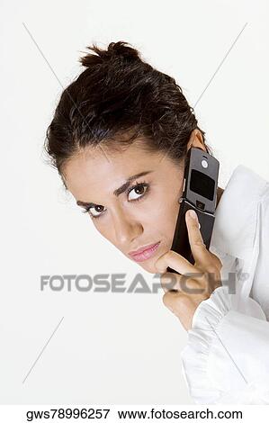 Portrait of a young woman talking on a mobile phone View Large Photo Image Stock Photo - Portrait of a young woman talking on a mobile phone. Fotosearch