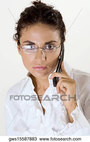 Portrait of a young woman using a mobile phone View Large Photo Image Stock Image - Portrait of a young woman using a mobile phone. Fotosearch
