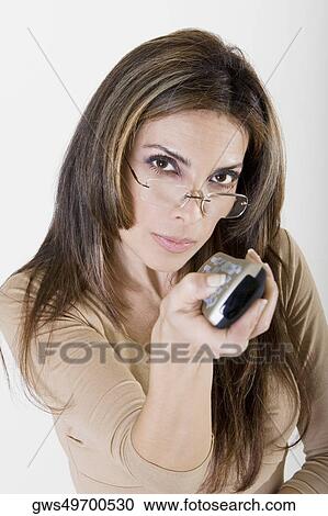 Portrait of a young woman using a remote control View Large Photo Image Stock Image - Portrait of a young woman using a remote control. Fotosearch