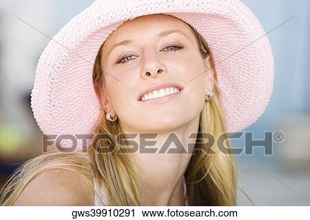 Portrait of a young woman wearing a hat View Large Photo Image Stock Image - Portrait of a young woman wearing a hat. Fotosearch