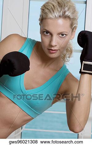 Portrait of a young woman wearing boxing gloves View Large Photo Image Stock Photo - Portrait of a young woman wearing boxing gloves. Fotosearch