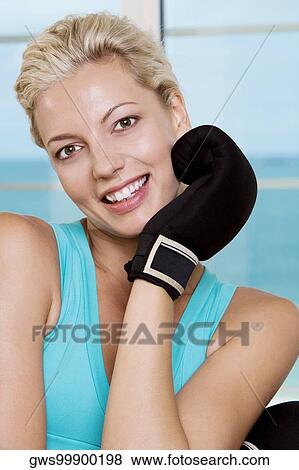 Portrait of a young woman wearing boxing gloves View Large Photo Image Stock Photo - Portrait of a young woman wearing boxing gloves. Fotosearch