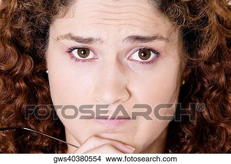 Portrait of a young woman with her hand on her chin View Large Photo Image Picture - Portrait of a young woman with her hand on her chin. Fotosearch