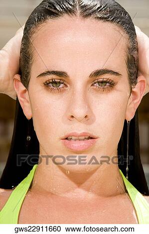 Portrait of a young woman with her hand in her hair View Large Photo Image Stock Image - Portrait of a young woman with her hand in her hair. Fotosearch