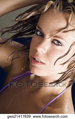 Portrait of a young woman with her hand in her hair View Large Photo Image Stock Photo - Portrait of a young woman with her hand in her hair. Fotosearch