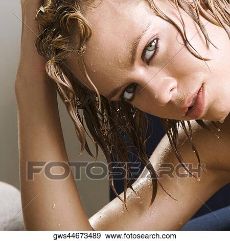 Portrait of a young woman with her hand in her hair View Large Photo Image Stock Photo - Portrait of a young woman with her hand in her hair. Fotosearch