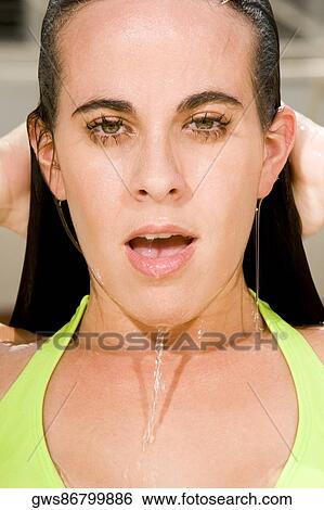 Portrait of a young woman with her hand in her hair View Large Photo Image Stock Photograph - Portrait of a young woman with her hand in her hair. Fotosearch