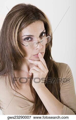 Portrait of a young woman with her finger on her lips View Large Photo Image Stock Photo - Portrait of a young woman with her finger on her lips. Fotosearch