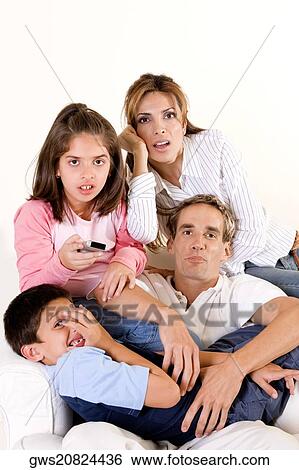 Portrait of parents and their son and daughter watching television View Large Photo Image Stock Photograph - Portrait of parents and their son and daughter watching television. Fotosearch