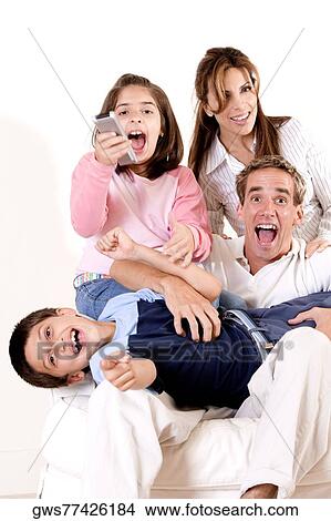 Portrait of parents watching television with their son and daughter View Large Photo Image Picture - Portrait of parents watching television with their son and daughter. Fotosearch