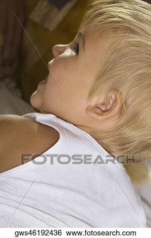 Rear view of a boy looking sideways View Large Photo Image Stock Photograph - Rear view of a boy looking sideways. Fotosearch