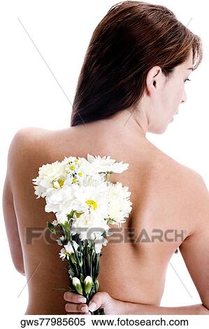 Rear view of a young woman hiding a bunch of flowers behind her back View Large Photo Image Stock Photography - Rear view of a young woman hiding a bunch of flowers behind her back. Fotosearch