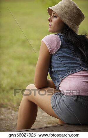 Rear view of a young woman sitting on the floor View Large Photo Image Stock Photography - Rear view of a young woman sitting on the floor. Fotosearch