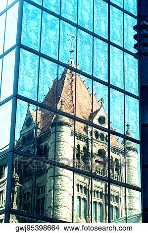 Picture - Reflection of a building on the glass front of an office building. Fotosearch
