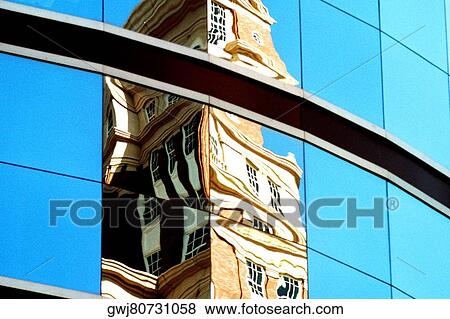 Reflection of a building on the glass front of an office building View Large Photo Image Stock Photo - Reflection of a building on the glass front of an office building. Fotosearch