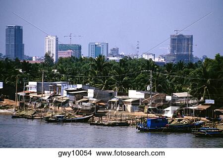 Picture - Saigon River contrasts with hi-rises in background, Vietnam. Fotosearch