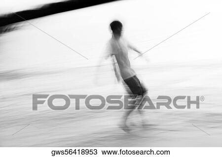 Stock Image - Side profile of a boy walking. Fotosearch