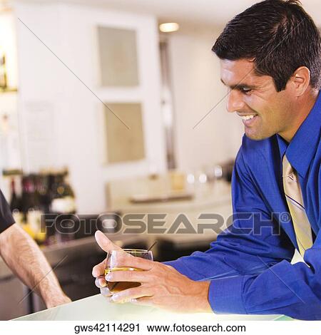 Side profile of a businessman holding a glass View Large Photo Image Stock Image - Side profile of a businessman holding a glass. Fotosearch