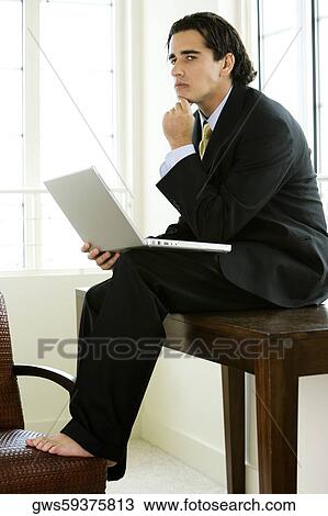 Side profile of a businessman holding a laptop View Large Photo Image Stock Image - Side profile of a businessman holding a laptop. Fotosearch