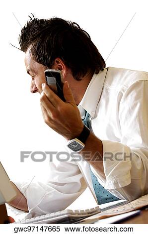 Side profile of a businessman holding a mobile phone View Large Photo Image Stock Photography - Side profile of a businessman holding a mobile phone. Fotosearch