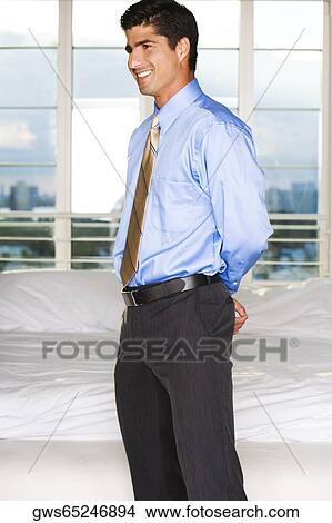 Picture - Side profile of a businessman smiling. Fotosearch