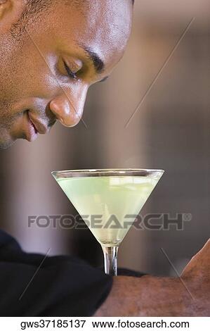 Side profile of a businessman with a glass of martini View Large Photo Image Stock Photo - Side profile of a businessman with a glass of martini. Fotosearch