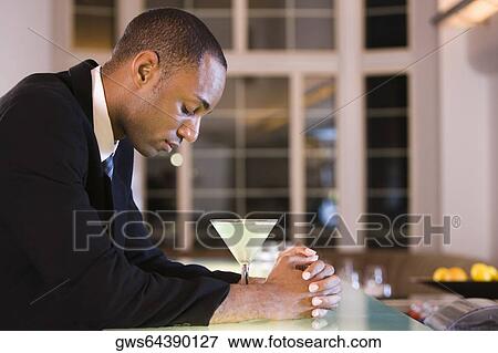 Side profile of a businessman with a glass of martini View Large Photo Image Stock Photo - Side profile of a businessman with a glass of martini. Fotosearch