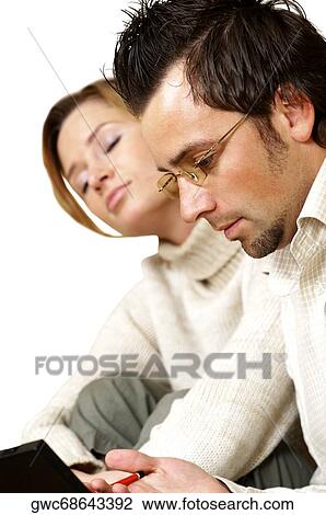Side profile of a businessman working with a businesswoman napping beside him View Large Photo Image Stock Image - Side profile of a businessman working with a businesswoman napping beside him. Fotosearch