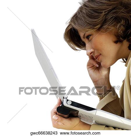 Side profile of a businesswoman holding a laptop View Large Photo Image Stock Image - Side profile of a businesswoman holding a laptop. Fotosearch