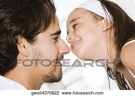 Side profile of a daughter looking at her father View Large Photo Image Stock Image - Side profile of a daughter looking at her father. Fotosearch