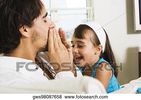 Stock Photo - Side profile of a father and his daughter. Fotosearch