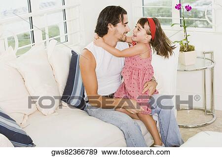 Side profile of a father hugging his daughter View Large Photo Image Stock Photo - Side profile of a father hugging his daughter. Fotosearch