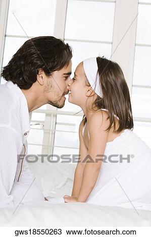 Side profile of a father looking at his daughter View Large Photo Image Stock Image - Side profile of a father looking at his daughter. Fotosearch